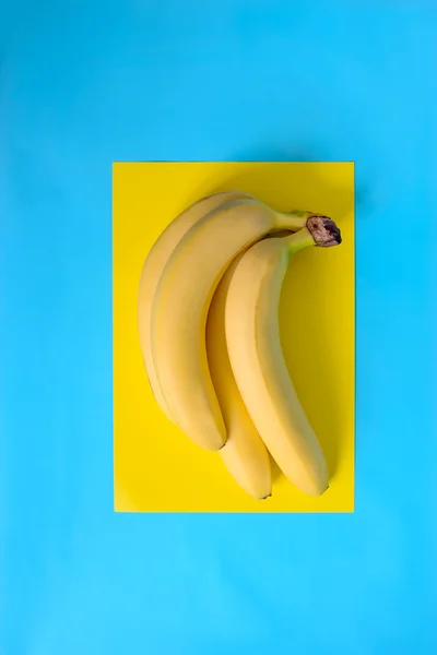 Bananas bunch on yellow — Stock Photo, Image