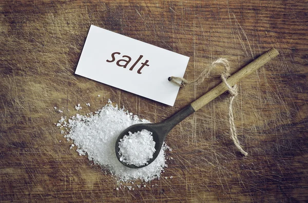 Sea salt in a rustic spoon — Stock Photo, Image