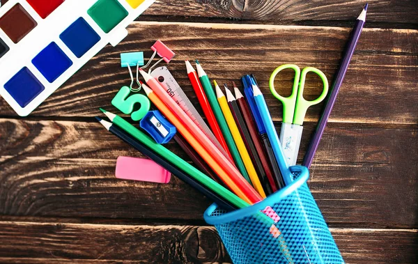 School supplies, paper clips, pencils, paints, marker, notepad, medical mask, eraser and bookmark.