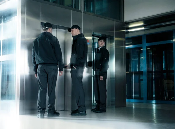 Asansörün Yanındaki Koridorda Duran Güvenlik Görevlileri Telifsiz Stok Imajlar