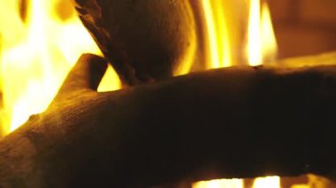 Şöminede yanan odun. 4K yavaş çekim videosu. Arka plan videoları. Alevler yavaşça yanan odunları dışarı çıkarıyor..