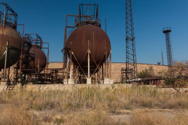 abandoned factory with rusty cisterns