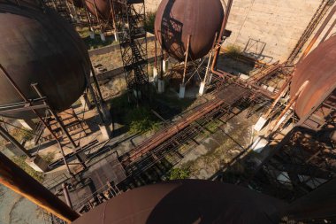 abandoned factory with rusty cisterns
