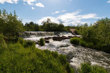 wide small waterfall in summer