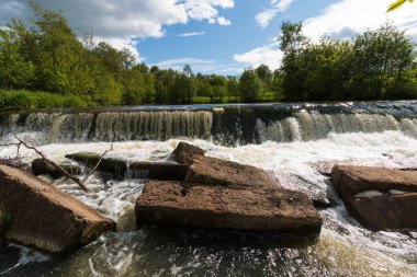 wide small waterfall in summer