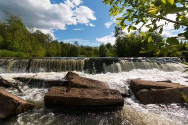 wide small waterfall in summer
