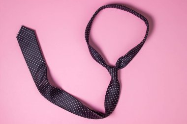 Siyah erkek kravatı. Pembe arka planda kravat. Erkek tarzı. Klasik erkek modası.