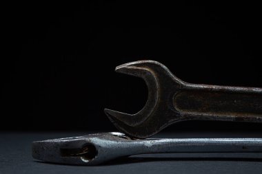 Siyah arka planda İngiliz anahtarı ve ayarlanabilir anahtar. Eski çalışma aletleri. Çelik aletler