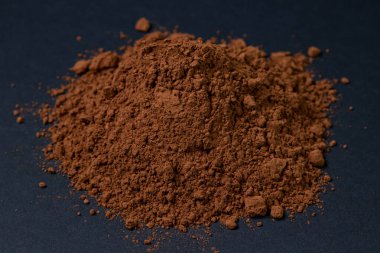 Siyah arka planda kakao tozu. Koyu arkaplanda çikolata tozu.