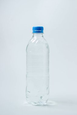 Beyaz arka planda su şişesi. Plastik şişe ve su. Temiz içme suyu.