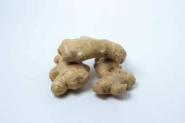 Beyaz arka planda zencefil. Zencefil kökü. Üç zencefil yan yana yatar.
