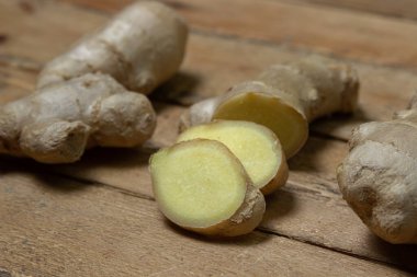 Ahşap arka planda zencefil. Zencefil kökü doğranmış. Sağlıklı yiyecekler. Sağlıklı gıda konsepti