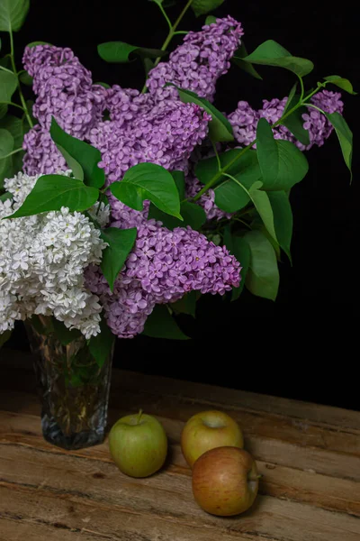 Lilacs of different varieties on a black background. Spring flowers. Lilac on a dark background