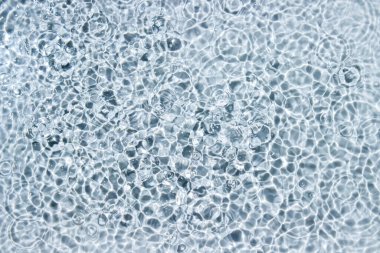 Circle ripples on water surface. Ripples on the water background. Pure clear water