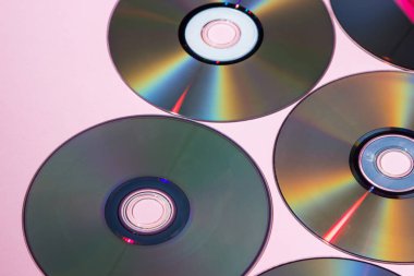 Compact discs on a pink background. Technologies of the past. Retro background