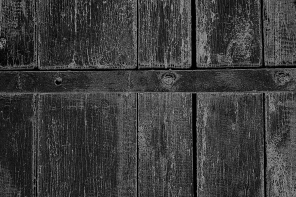 Old plank wooden wall background. The texture of old wood. Weathered piece of wood.