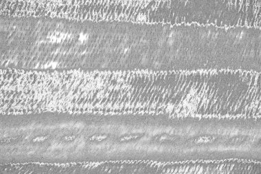 Çizik ve çatlaklarla dolu gri bir doku.