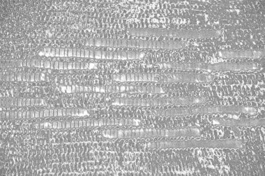 Çizik ve çatlaklarla dolu gri bir doku.