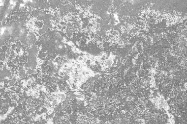 Çizik ve çatlaklarla dolu gri bir doku.