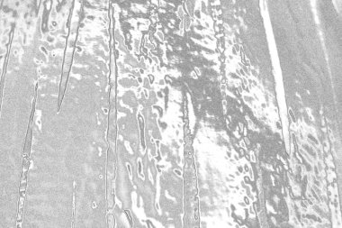 Çizik ve çatlaklarla dolu gri bir doku.