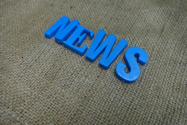 News concept. Blue letters on a background