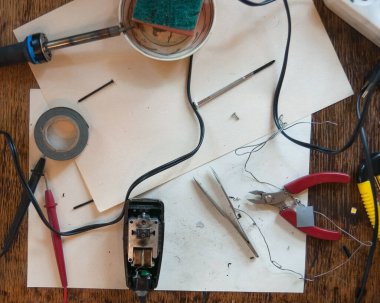 Elektrikli aletleri tamir etmek için araçları olan mühendislerin işyerlerinin üst görünümü