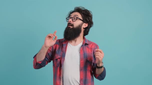 Close up of a sick man sneezing. Bearded man isolated on turquoise background. — Stock Video
