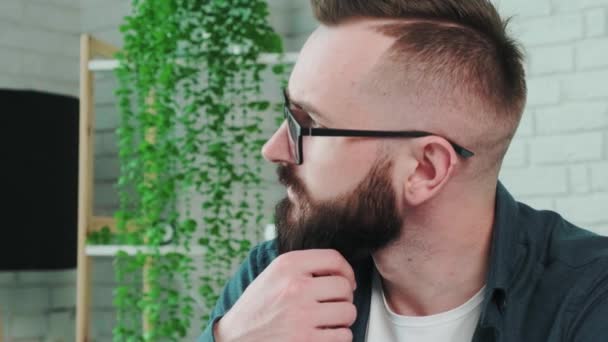 Close up of a young man resting at home and thinking about the future. — Stock Video