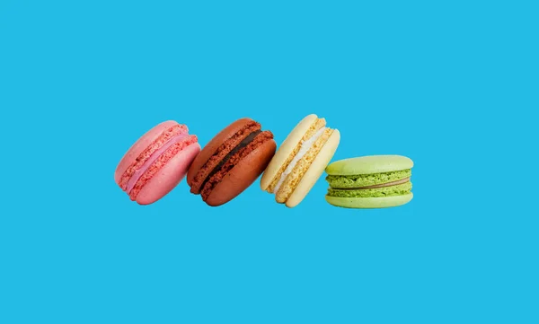 Green Yellow Brown Pink Macarons Isolated Blue Background Shadow — Stock Photo, Image