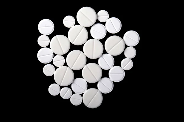 A picture of white medicine pills isolated on black — Stock Photo, Image