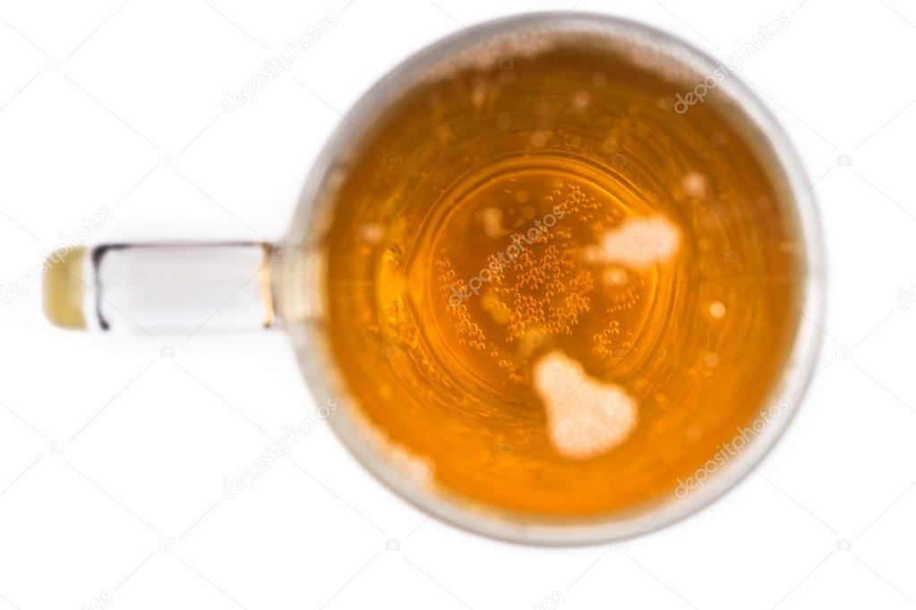 top view of glass of beer on white background