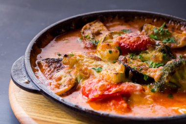 Buğulanmış sebze koyu arka plan üzerinde bir tavada karıştırın. yakın çekim