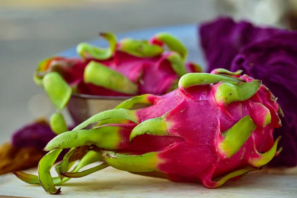 whole colorful bright pink and green dragonfruit natural organic raw cactus fruit
