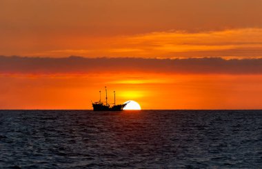 Okyanusta Bir Korsan Gemisi Renkli Turuncu Günbatımına Karşı Oturuyor