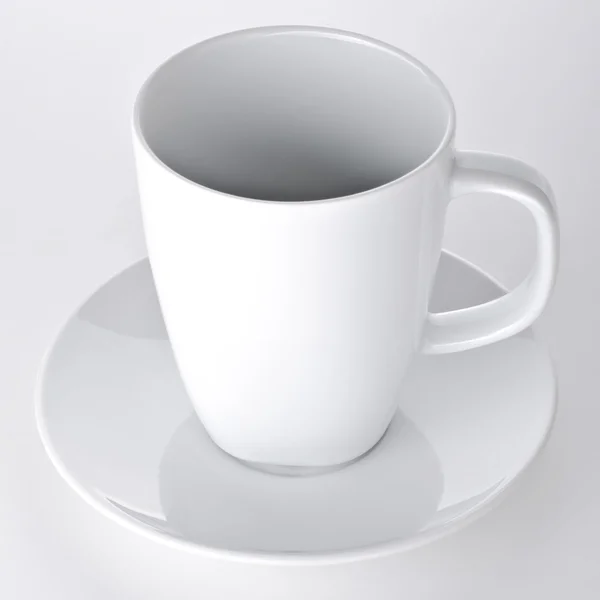 Белая чашка с блюдцем — стоковое фото