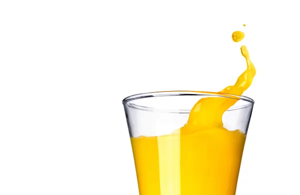 Splashing orange juice in glass — Stock Photo, Image