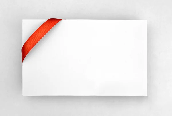 Red ribbon on paper card — Stock Photo, Image