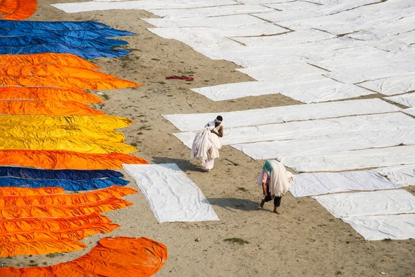 Agra, Hindistan - 15 Şubat 2018: Kimliği belirsiz insanlar Yanuma Agra nehrinin kıyısında sıcak güneşte yıkandıktan sonra bez kurutuyorlar 