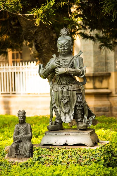 An ancient Indian sculpture of the Hindu god and goddess carved in stone.