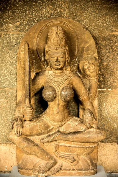 An ancient Indian sculpture of the Hindu god and goddess carved in stone.