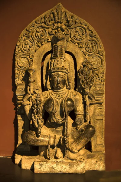 An ancient Indian sculpture of the Hindu god and goddess carved in stone.