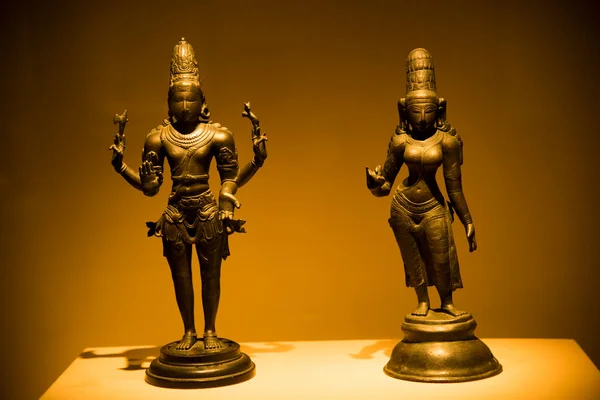 Ancient metal sculpture of the Indian Hindu god and goddess