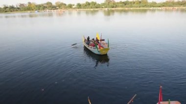 MATHURA, INDIA - 10 Mart 2017: Yamuna nehrinin kıyısında teknede yüzen kimliği belirsiz bir grup Hintli. Mathura, Uttar Pradesh 'in bir din kentidir..