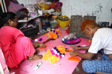 AMRAVATI, MAHARASHTRA, INDIA, October 12,  2020 : People making Garland at their home for festival.