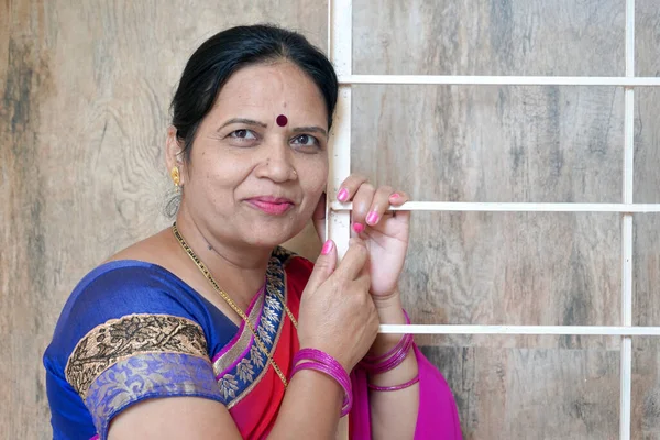 Portrait of smiling and happy Indian woman wearing sari.