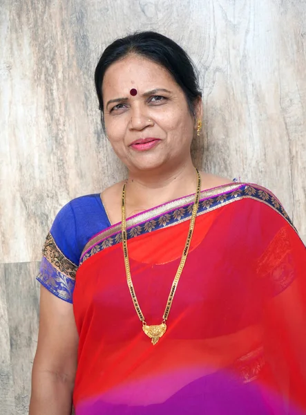 Portrait of smiling and happy Indian woman wearing sari.