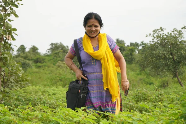 Indian woman in meadow and enjoying nature.