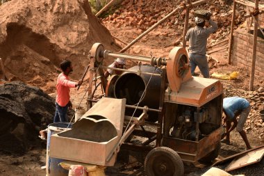 MUMBAI, MAHARASHTRA, INDIA 19 DECEMBER 2019 : Construction workers working on a building development site. In India building workers are not wear any safety measures at work.
