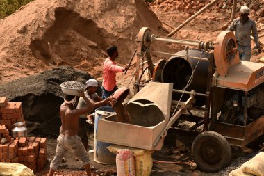 MUMBAI, MAHARASHTRA, INDIA 19 DECEMBER 2019 : Construction workers working on a building development site. In India building workers are not wear any safety measures at work.