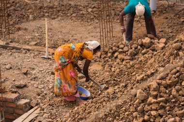 MUMBAI, MAHARASHTRA, INDIA 19 DECEMBER 2019 : Construction workers working on a building development site. In India building workers are not wear any safety measures at work.